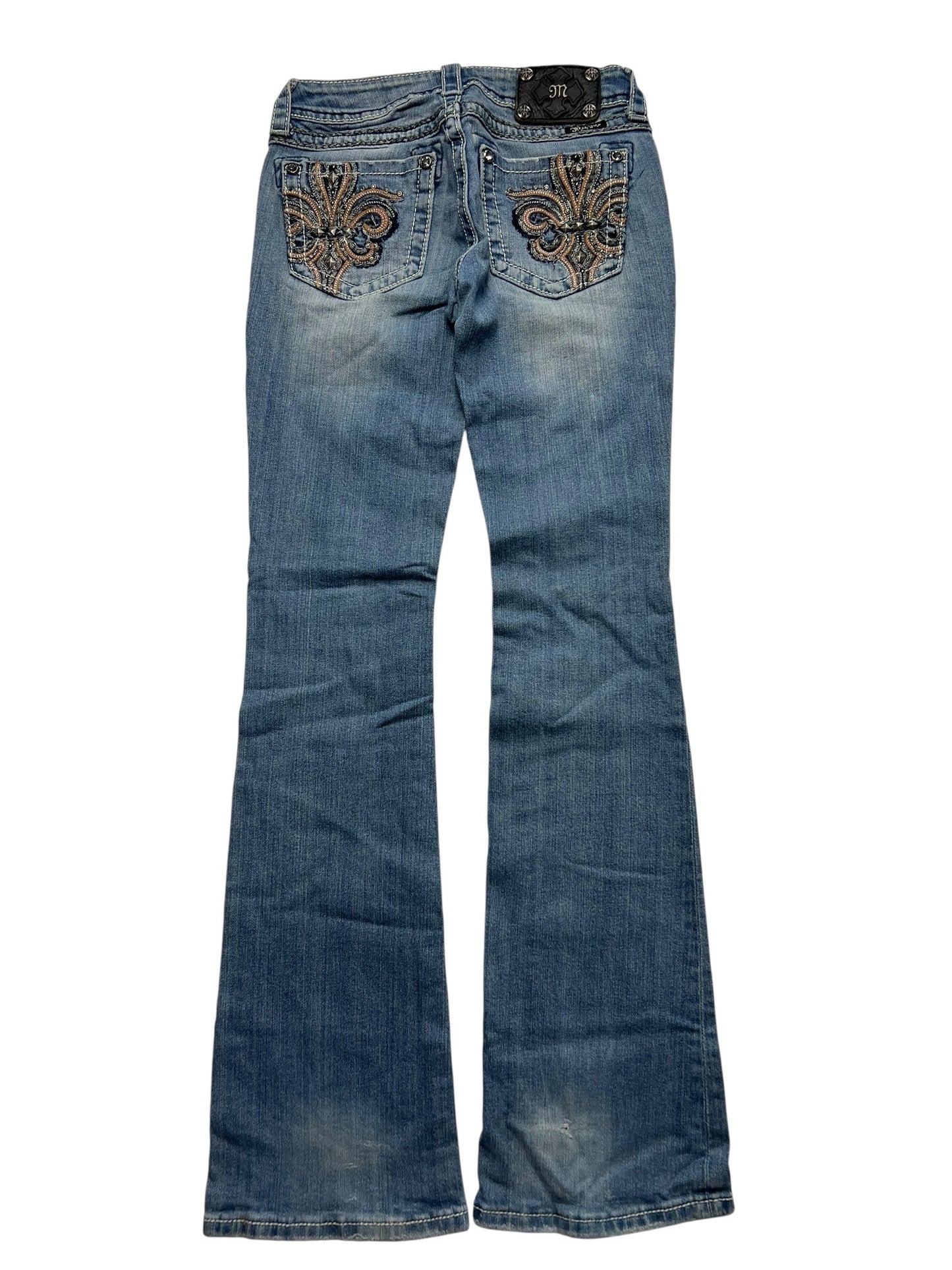 Ein Paar Miss Me Low Rise Boot Jeans von ZAZA resell in Größe 26 (S)ki, blauer Bootcut-Stil mit dekorativer Stickerei auf den Gesäßtaschen, flach auf weißem Hintergrund für eine ideale Passform dargestellt.