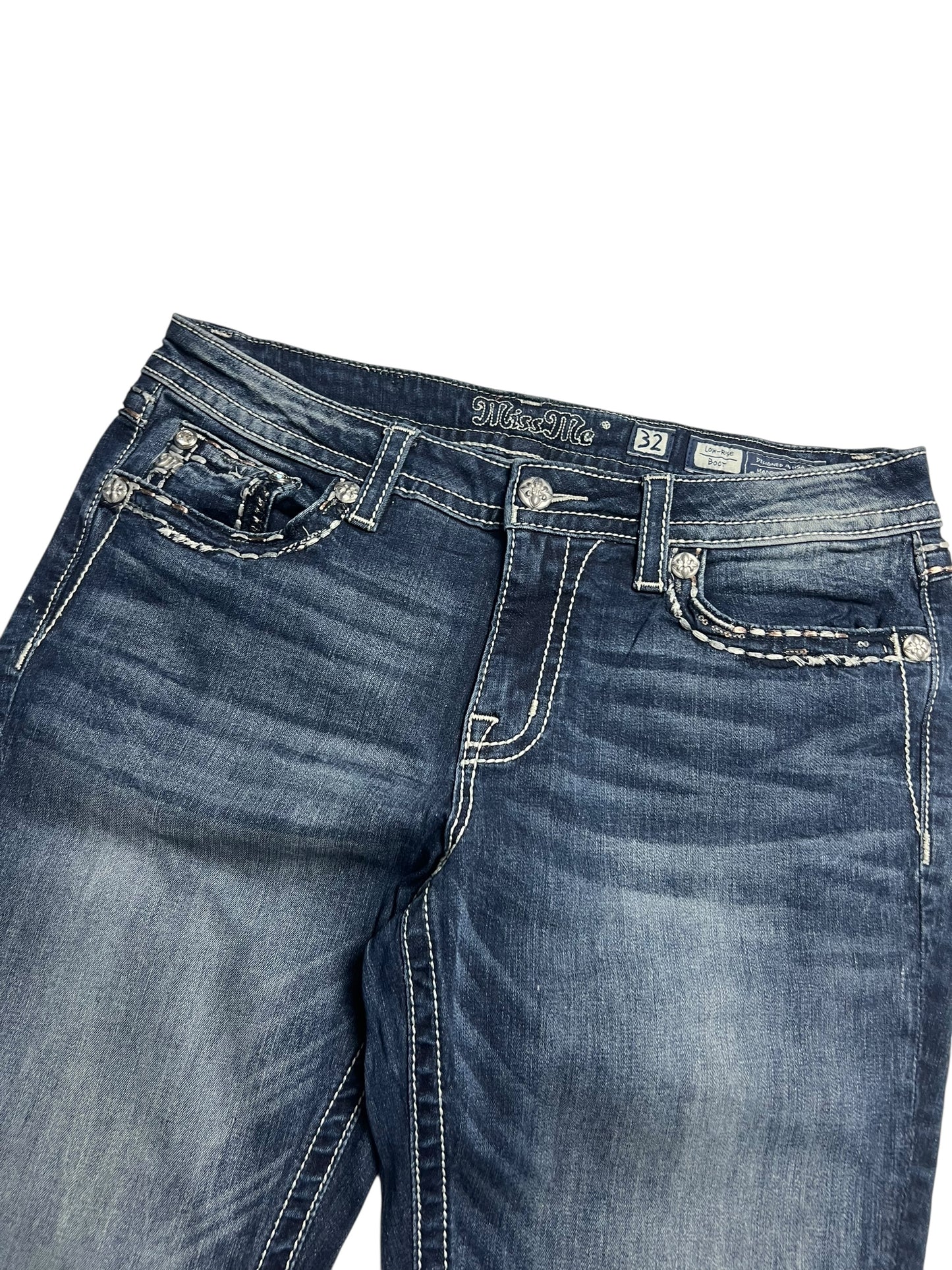 Die Miss Me Low Rise Boot Jeans in Größe 32 (L) von ZAZA resell hat blauen Denim, weiße Kontrastnähte, genietete Vordertaschen und einen verblichenen, leicht abgenutzten Look.