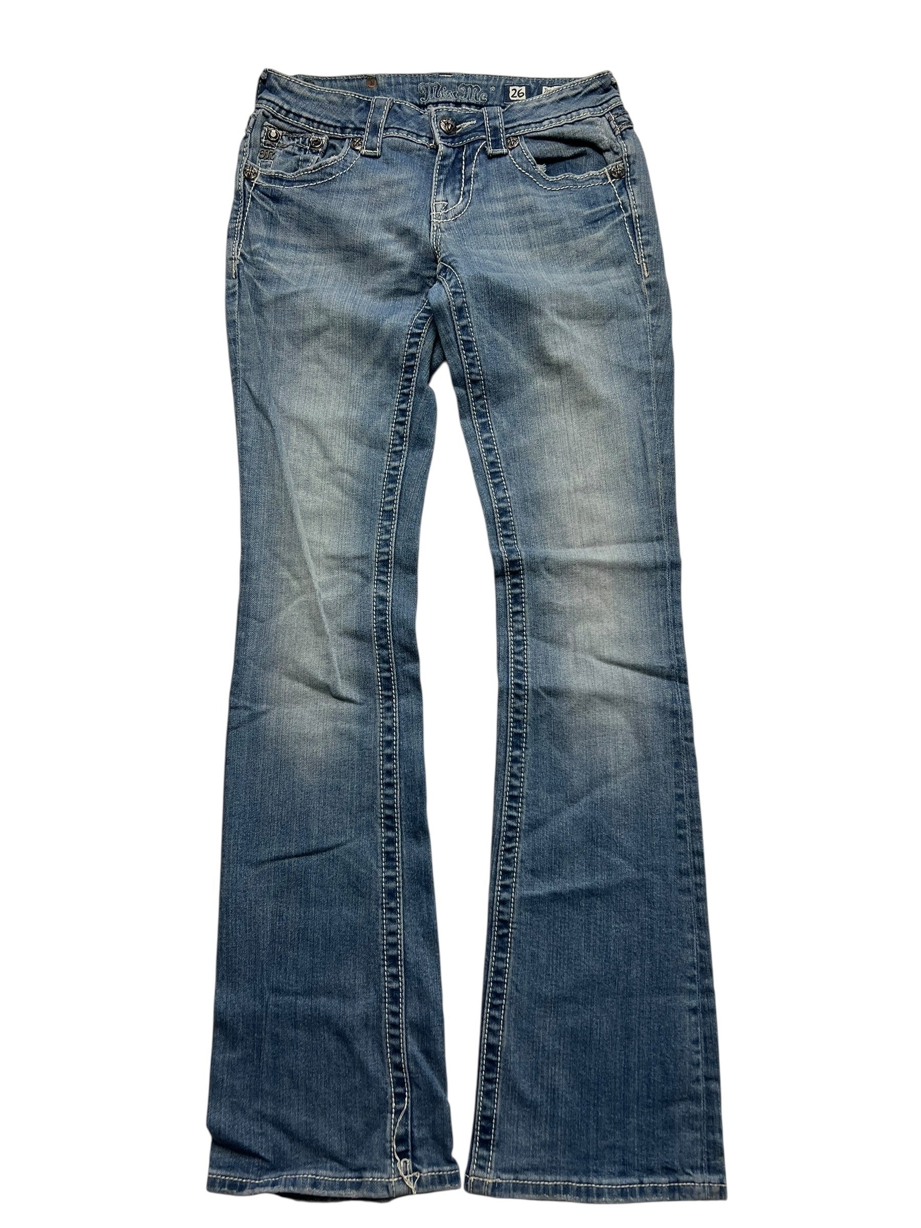 Ein Paar Miss Me Low Rise Boot Jeans (Größe 26, von ZAZA resell) aus blauem Denim mit verblichenen Details und Kontrastnähten, flach auf weißem Grund.