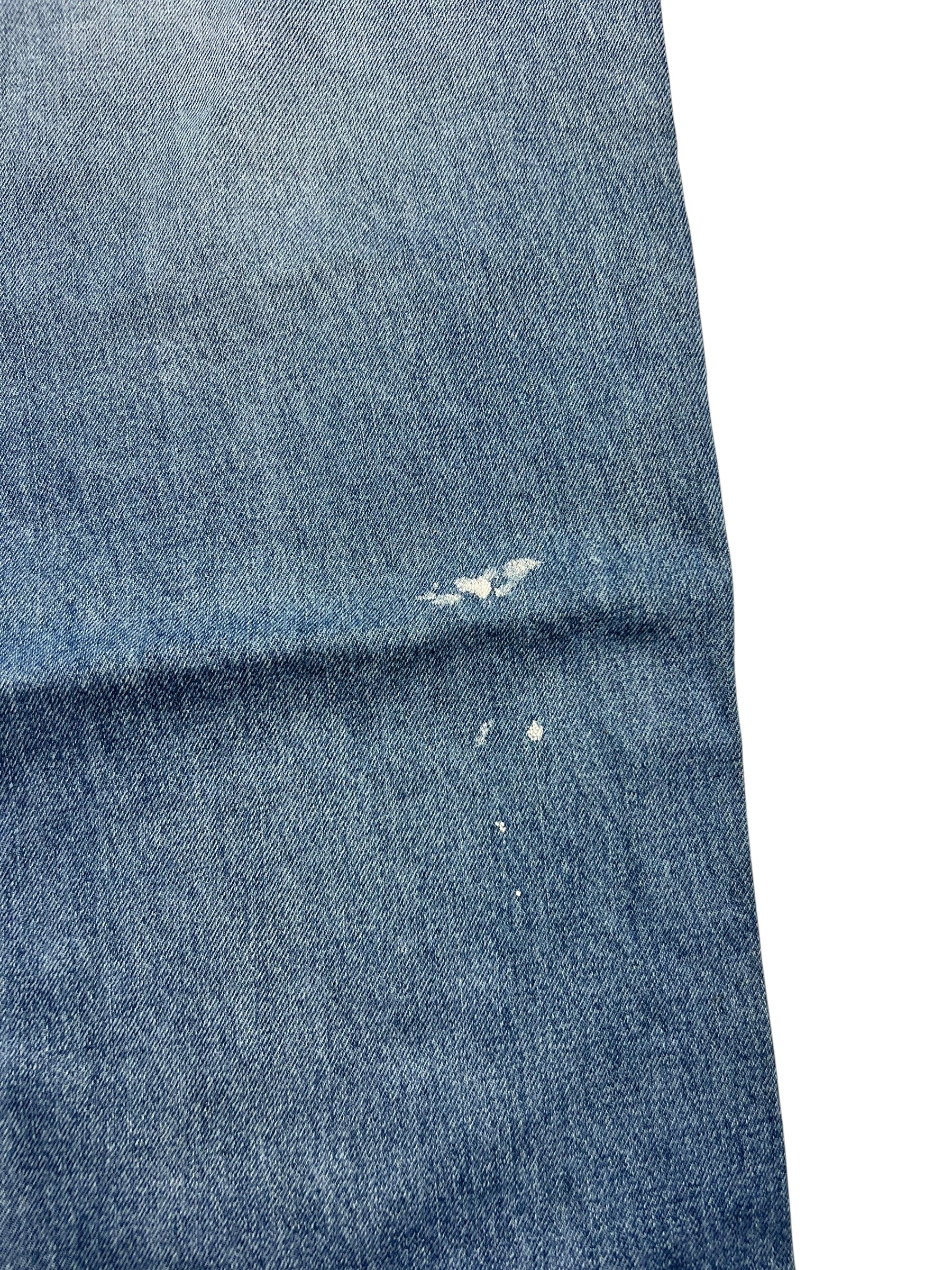 Ein blauer Denimschnitt mit abgenutzten Löchern und Distressed-Spots, gesetzt auf Weiß-Attribute wie Bundweite und Labelgröße machen die True Religion Straight | 34 (L) von ZAZA resell perfekt für eine detaillierte Bekleidungsanalyse.